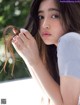 A woman with long brown hair is posing for a picture.